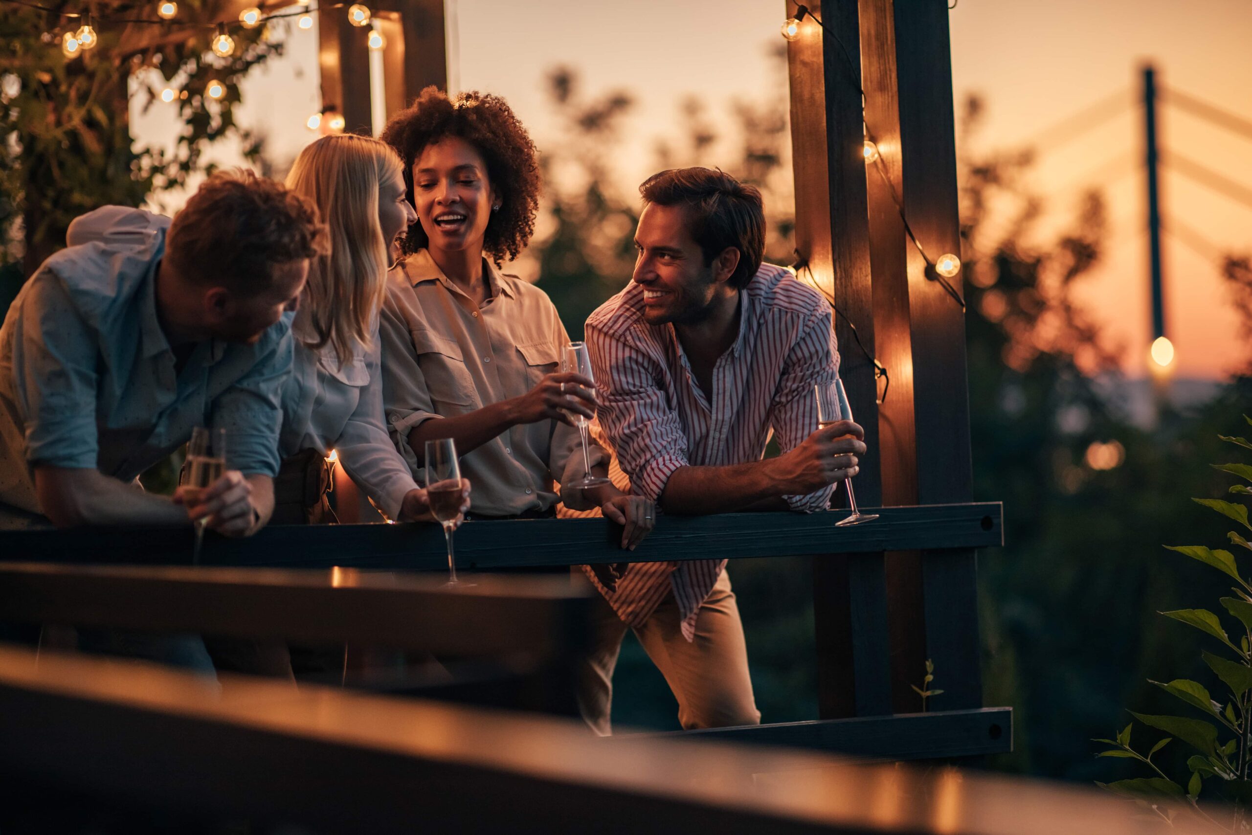 People enjoying wine at sunset